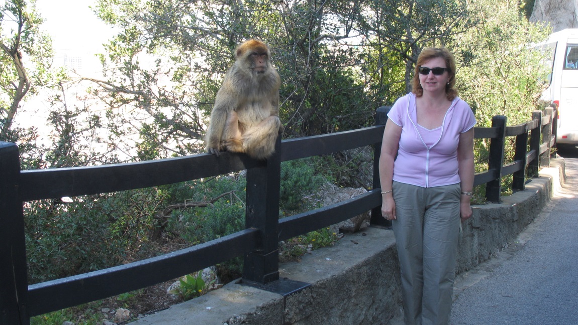 Tourist posing with a Barbary macaque