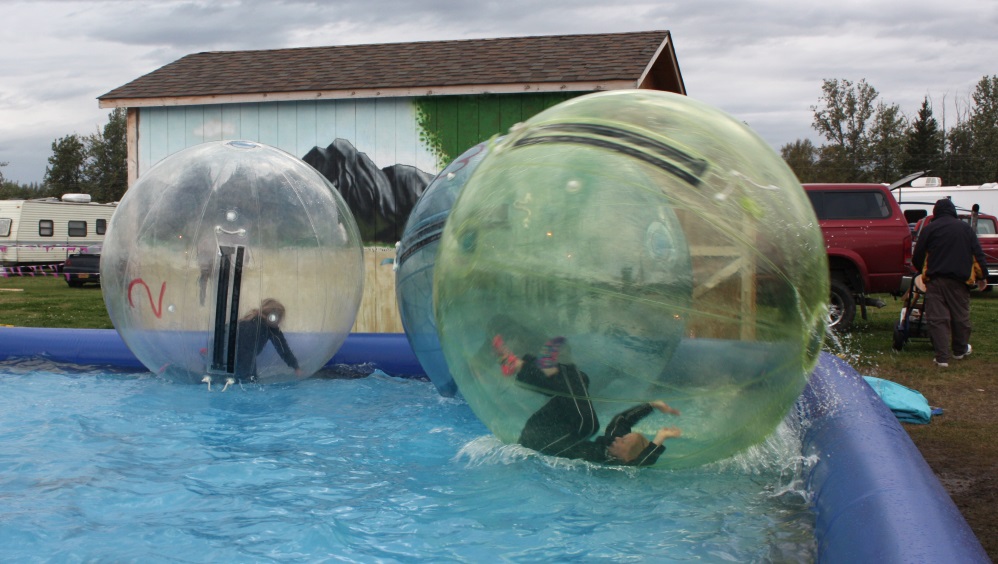 kids climb inside the plastic ball which is then sealed and inflated