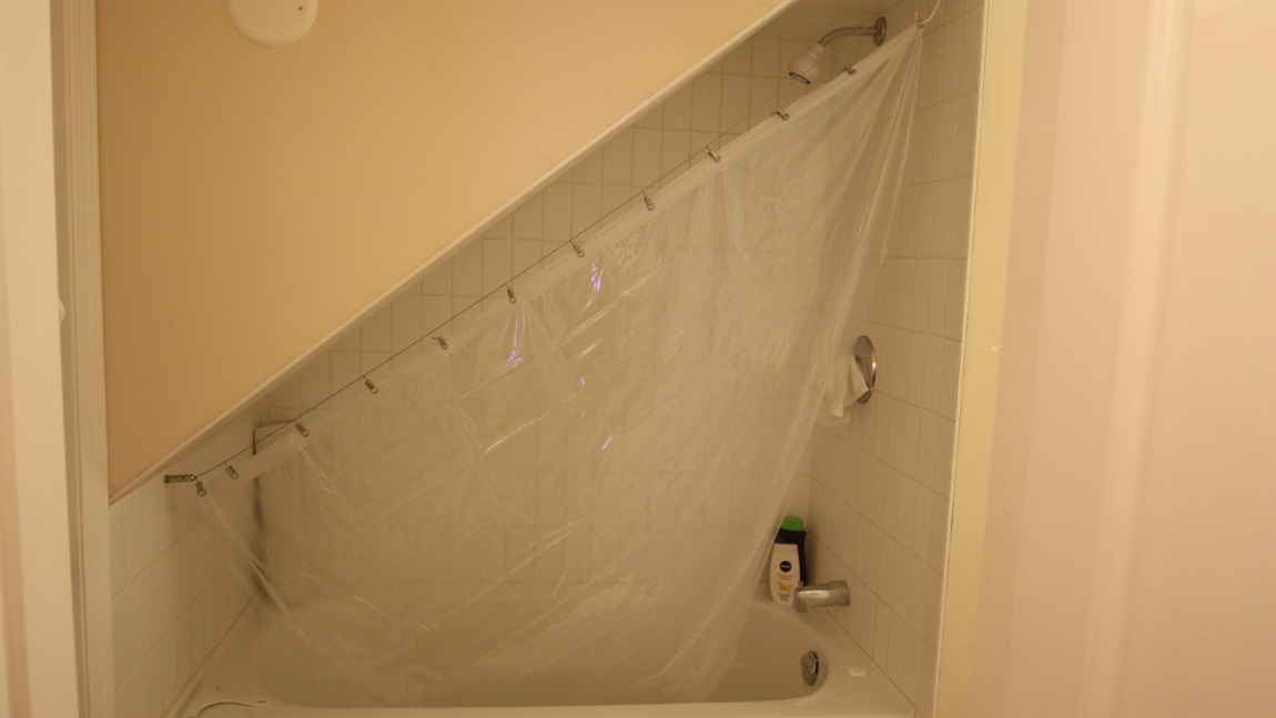 Creative shower under a staircase