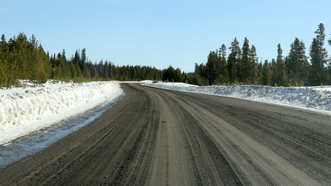 Road continues wet mud over ice